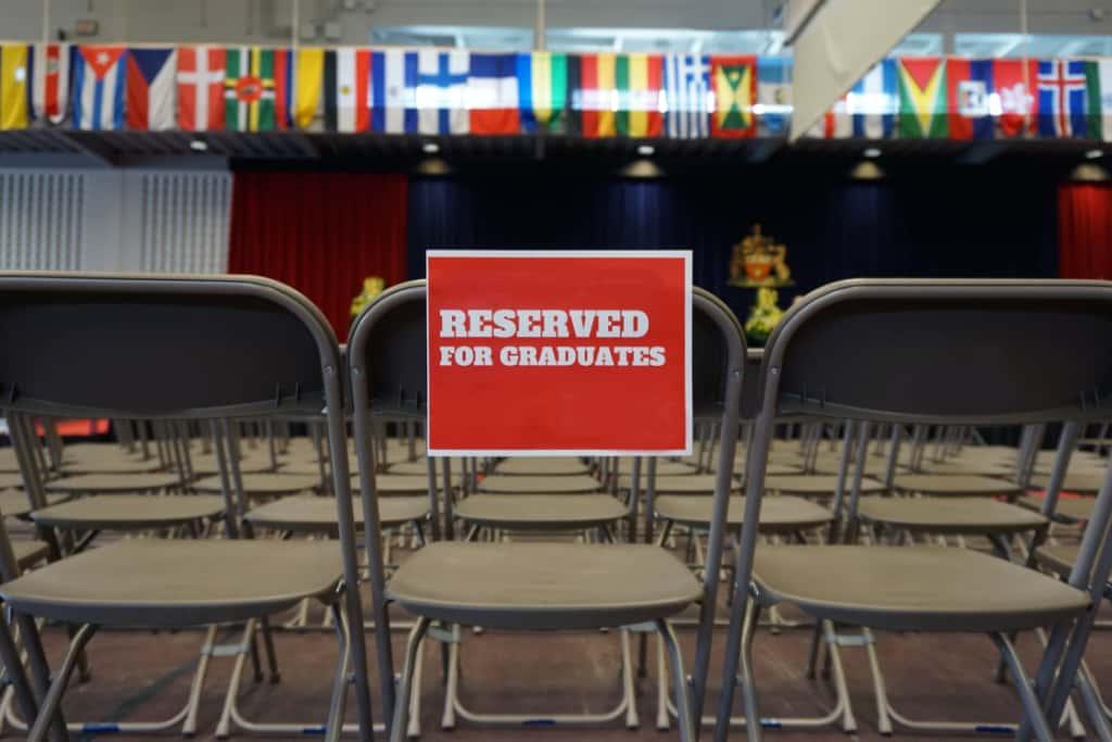 Rows of empty chairs reserved for graduates at a graduation ceremony